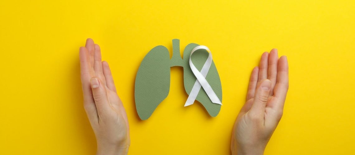 Lung Cancer Awareness Month concept on yellow background